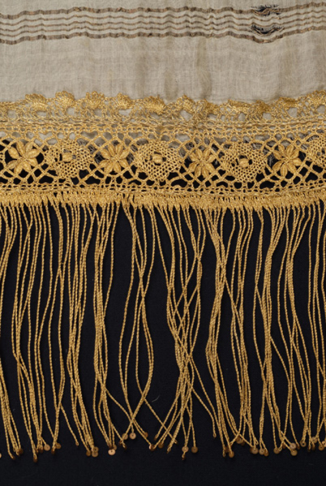 Gold fringe, gold lace kopaneli (bobbinet) with geometrical and flower motifs. It ends to fringes with darning gold spangles 