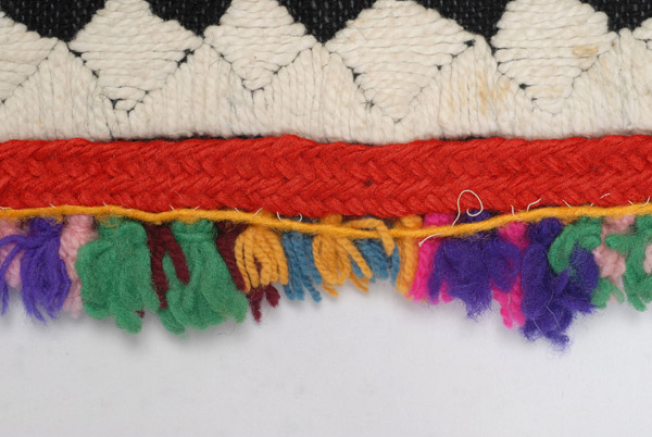 Detail of the decoration, applique woollen gaitani, woollen cord and small fringes made of sayiaki (fullen wool fabric) at the edge