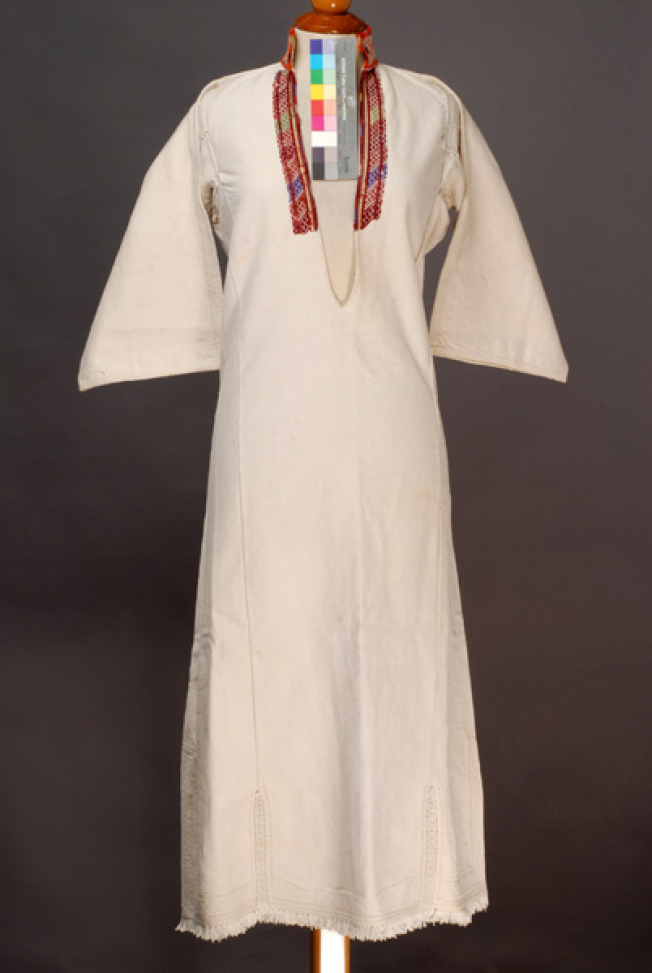 White cotton woven chemise, ornamented with woollen coloured embroideries