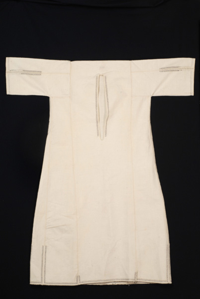 White cotton woven chemise with uncut neckband, ornamented with black beads