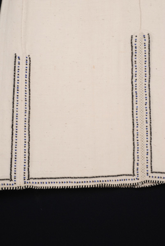 Border, detail of the embroidered joint of the seam and the applique decoration with colourful beads