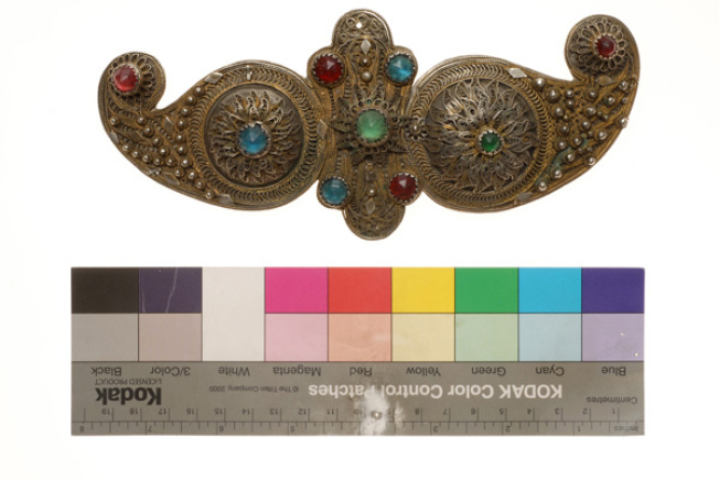 Gilded buckle with wiry multi-leafed rosettes and multicoloured stones