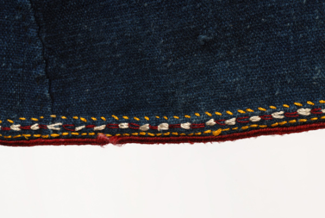 Detail of the embroidery at the hem of the overcoat