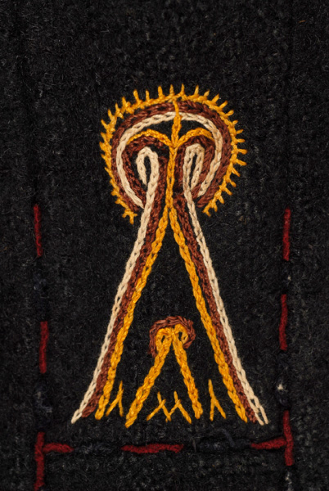 Detail of the decoration at the side, embroidered stylized motif