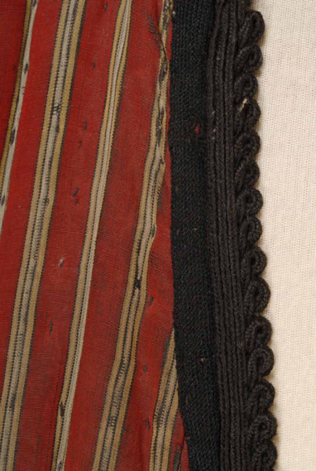 Detail of the inweave and the applique decoration at the chest