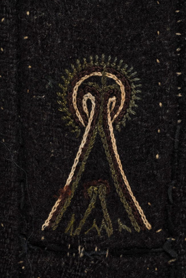 Detail of the decoration at the side, embroidered stylized motif