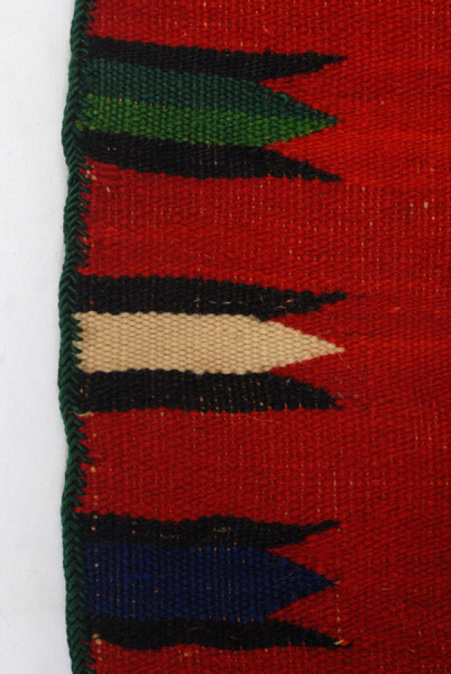 Detail of the embellished decoration: dachtyoua at the vertical sides