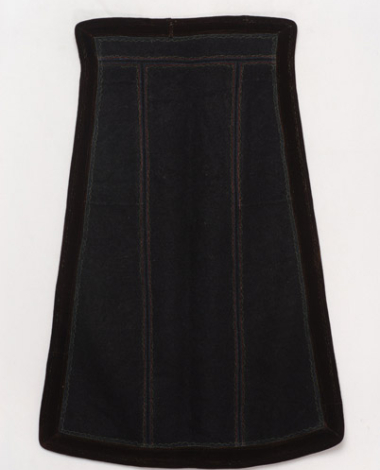 Black skoutisia apron, ornamented with plain multicoloured stitches around, trimmed with brown velvet band