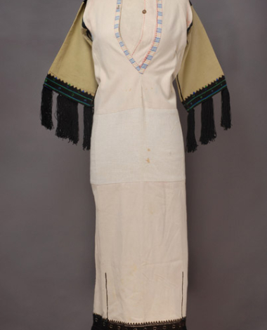 White cotton chemise, embroidered with black and coloured woollen threads 