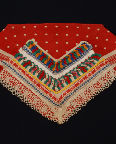 Triangle additional plastron made of red cotton printed fabric with applique decoration