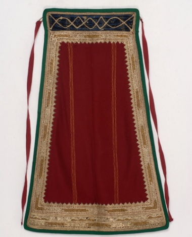 Karagounian apron made of crimson felt. Decoration with gold and white cordons. 