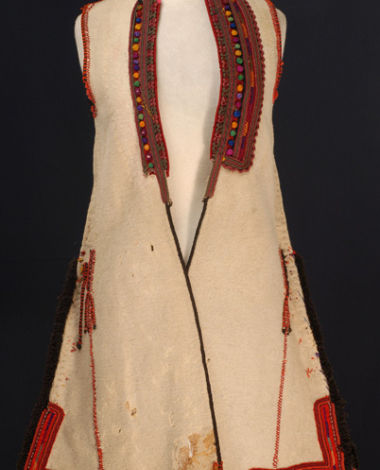 Sagias, sleeveless, white overcoat decorated with colourful cordons and colourful knitted woollen buttons