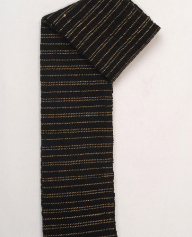 Handwoven black woollen sash with embellished narrow stripes in a horizontal arrangement, folded lengthwise
