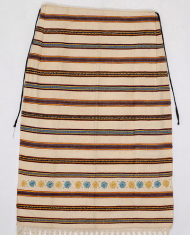 White cotton striped apron. Edge, composition of tassels made with thread