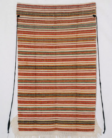 Striped wool apron. Trimming of a knitted composition with fringed end