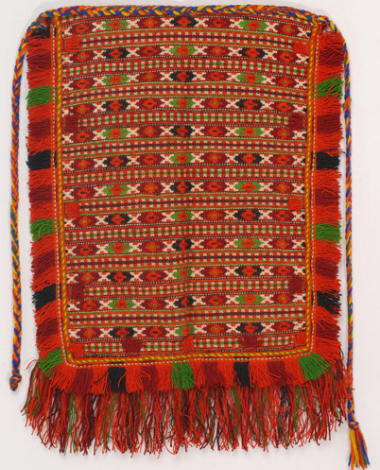 Woollen woven apron with embellished geometrical motifs in orange colour, embellished with green, crimson and black colour and double fringed edge at the bottom part