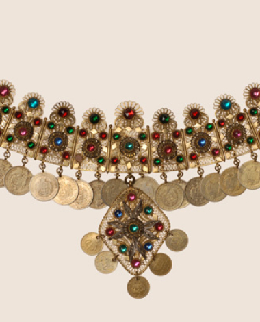 Wiry gilt yordani decorated with variegated glass stones and coins