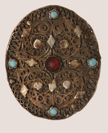 Gilt filigree breast pin decorated with red stones and turquoise 