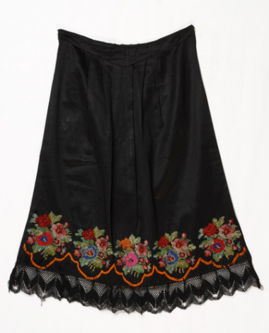 Black satin apron embroidered with multicoloured flower motif