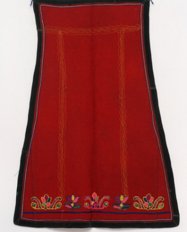 Skoutisia (woollen) apron on red colour, embroidered with silk outres (silk braids) and woollen threads