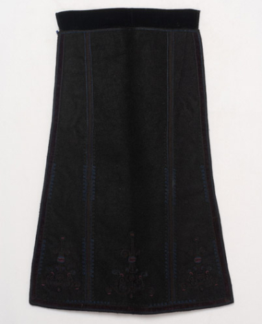 Black skoutisia apron embroidered with dark coloured silk outres (silk braids) and trimmed around with crimson velvet