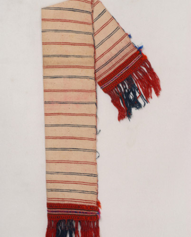 Karpa, white cotton woven towel, with embellished multicoloured patterns at the two edges and fringed edge