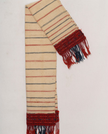 Karpa, white cotton woven towel, with embellished multicoloured patterns at the two edges and fringed edge
