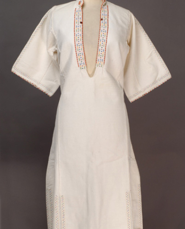 White cotton woven chemise, ornamented with mat and glistening beads, buttons and embroideries with coloured cotton threads 