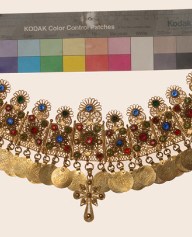 Wiry gilt yordani decorated with variegated glass stones, gilded coin imitations and a wiry cross